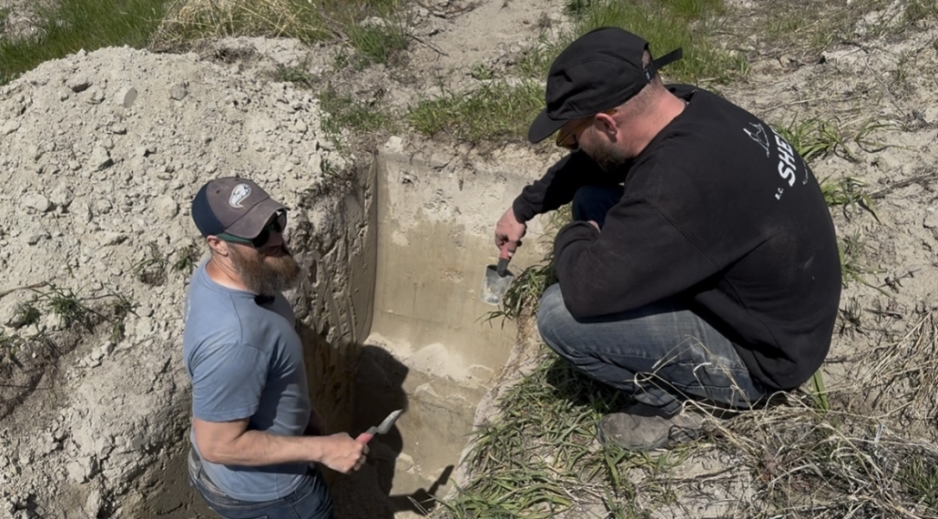 Chris from Vintality and Richard Charnock from JoieFarm Winery in a hole at Smethurst Vineyard surveying soil
