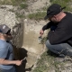 Chris from Vintality and Richard Charnock from JoieFarm Winery in a hole at Smethurst Vineyard surveying soil